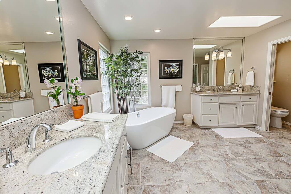 bathroom design with freestanding bath tub and vanity