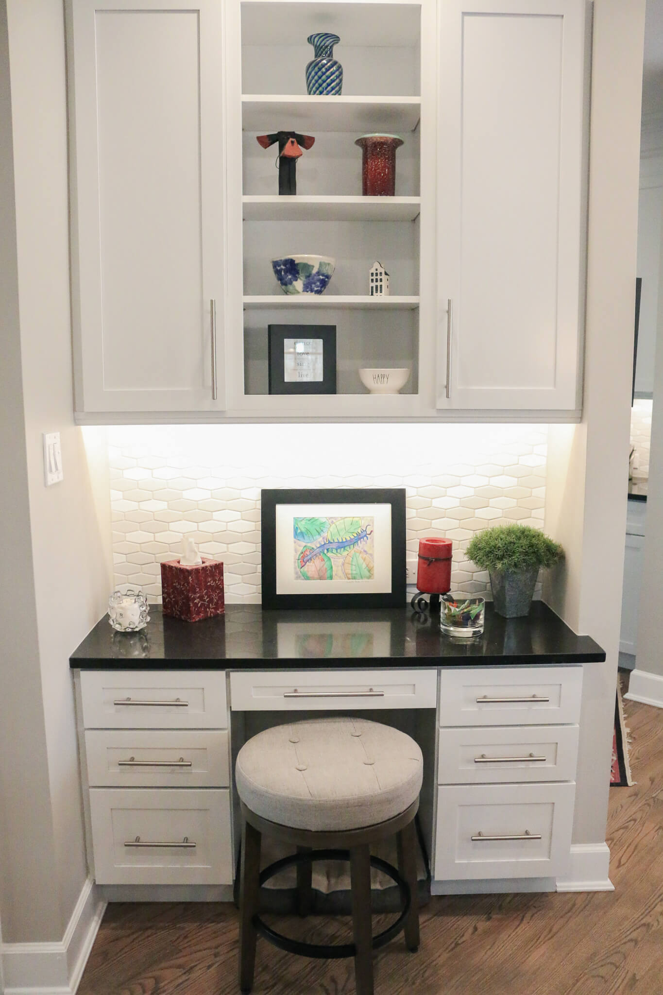 corner side for sitting with white cabinets black countertop and a stool