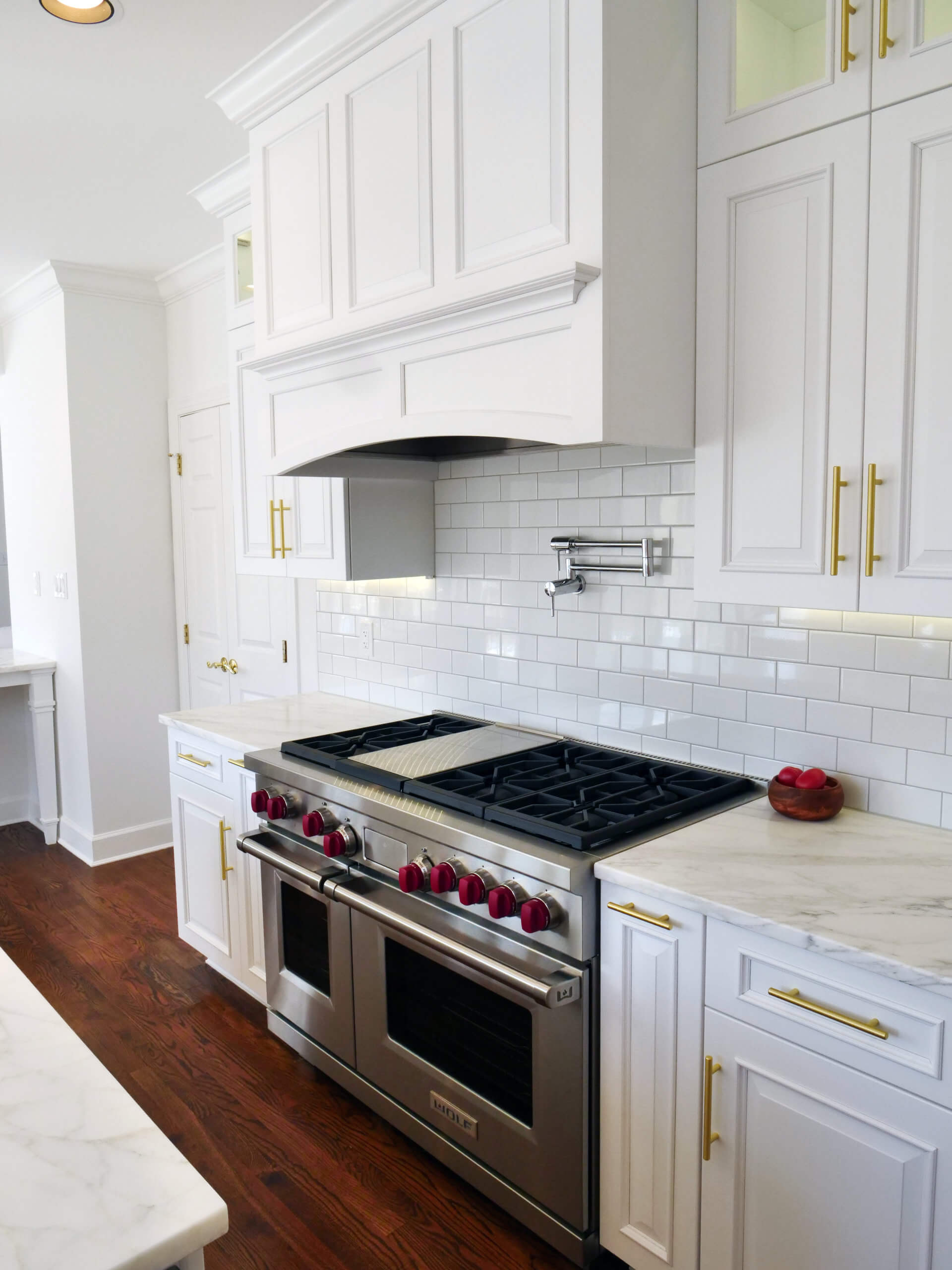 burner side of Marble white counters and cabinets in newly remodeled kitchen