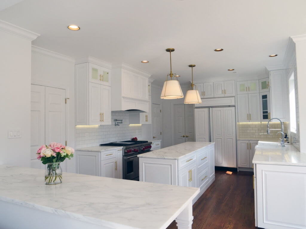 Marble white counters and cabinets in newly remodeled kitchen