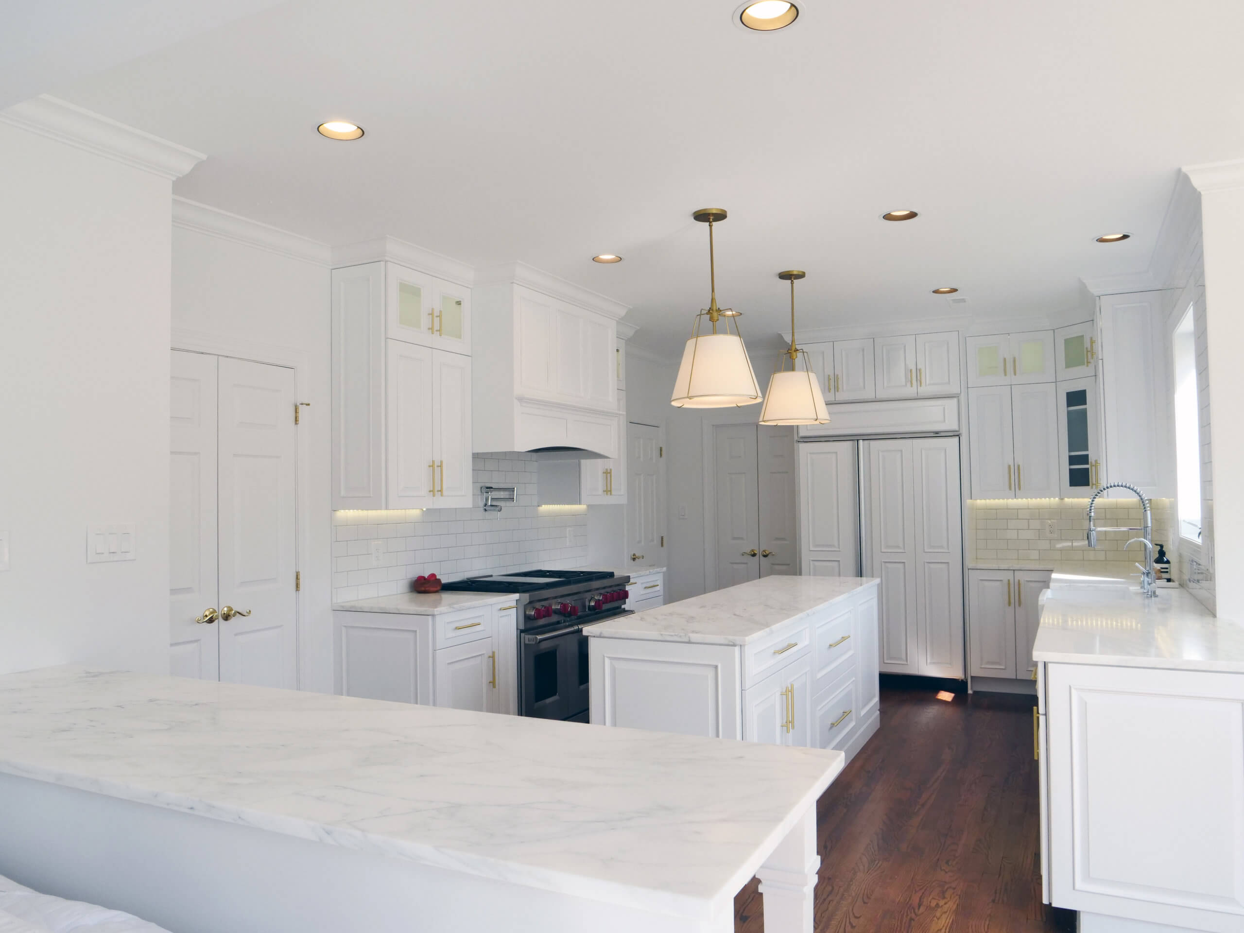 Marble white counters and cabinets in newly remodeled kitchen