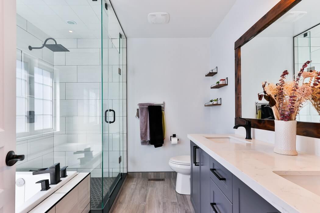 Modern Bathroom finished with glass shower, quartz counter top and wood floors