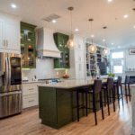 Completed kitchen renovation service. Modern kitchen with green cabinetry and large island