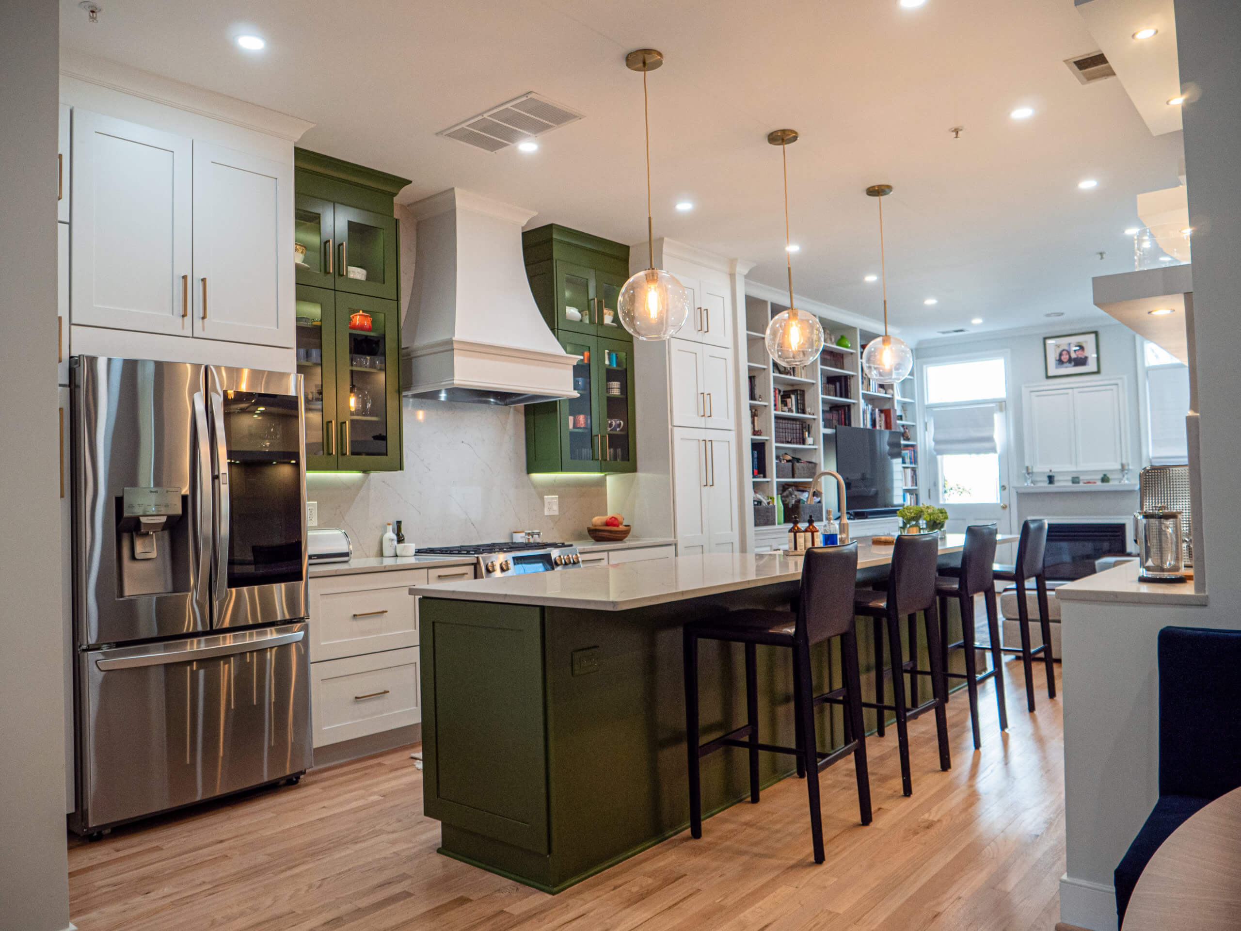 Completed kitchen renovation service. Modern kitchen with green cabinetry and large island
