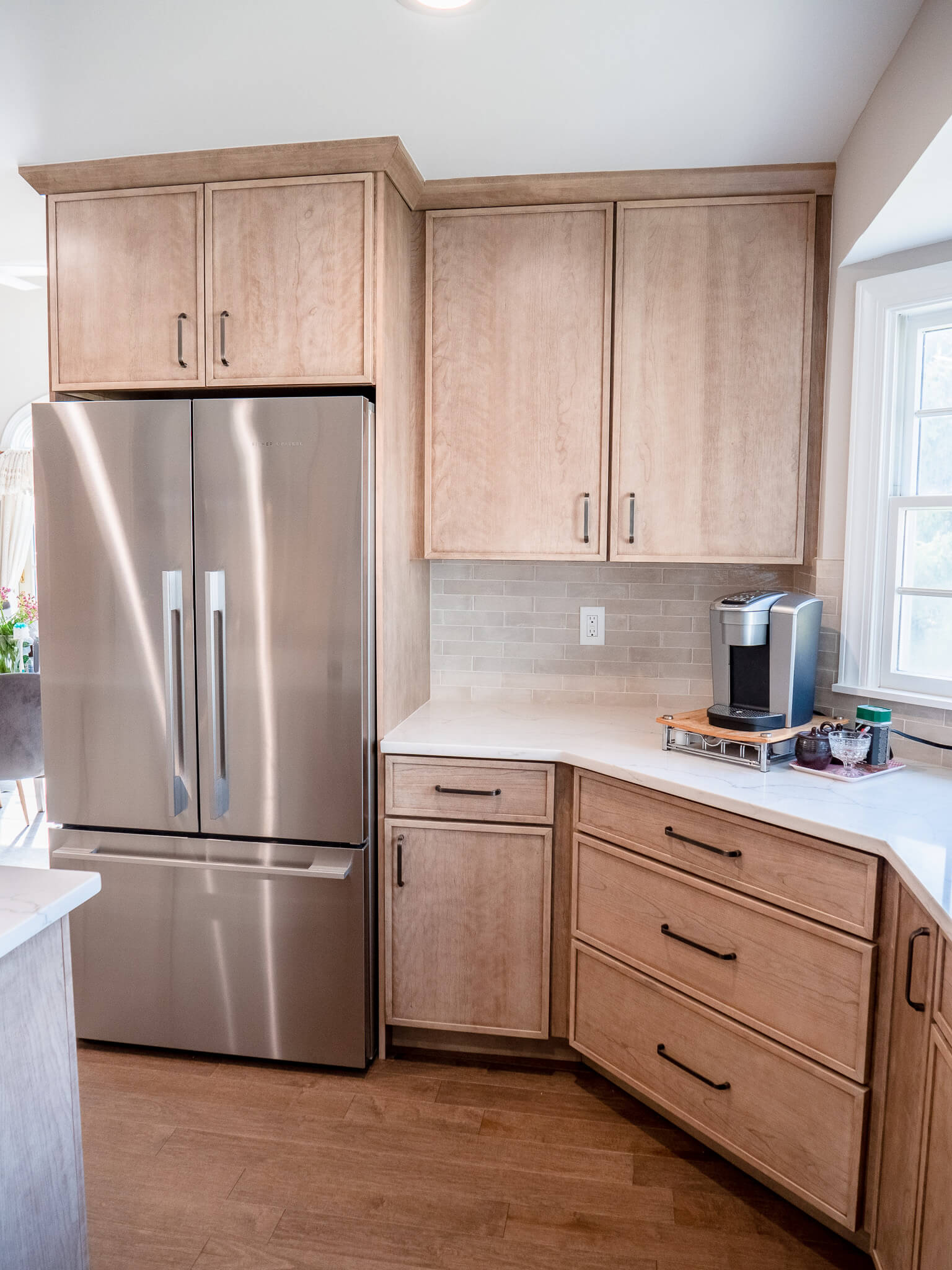 View of kitchen cabinets and refrigerator