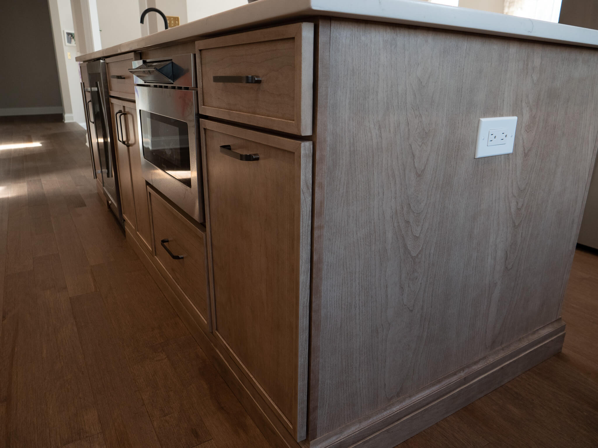 close up view of wooden cabinets and microwave