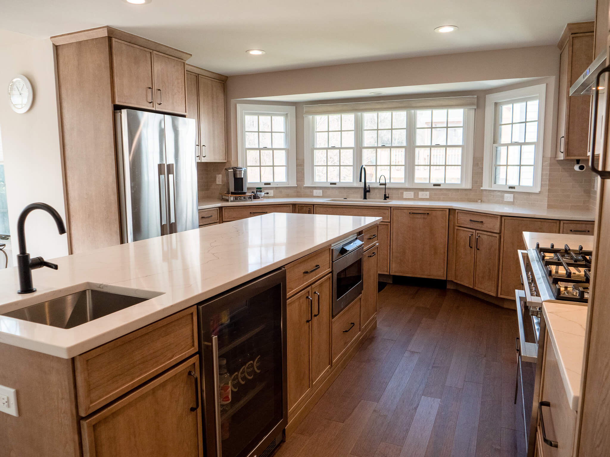 a classic look of a kitchen with wooden floor and cabinets