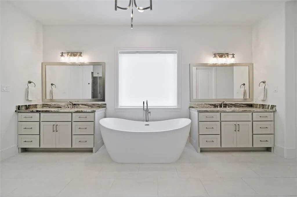 Master bathroom remodel with soaking tub between dual vanities | Best bathroom remodeling