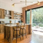 rustic kitchen with large kitchen windows and exposed light bulbs