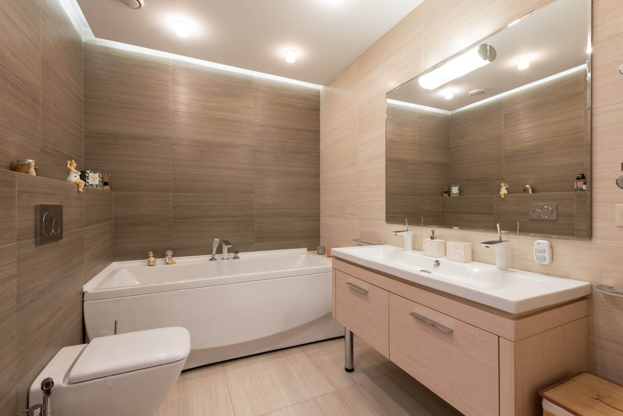 Bathroom lights in a neutral-colored bathroom with mirror