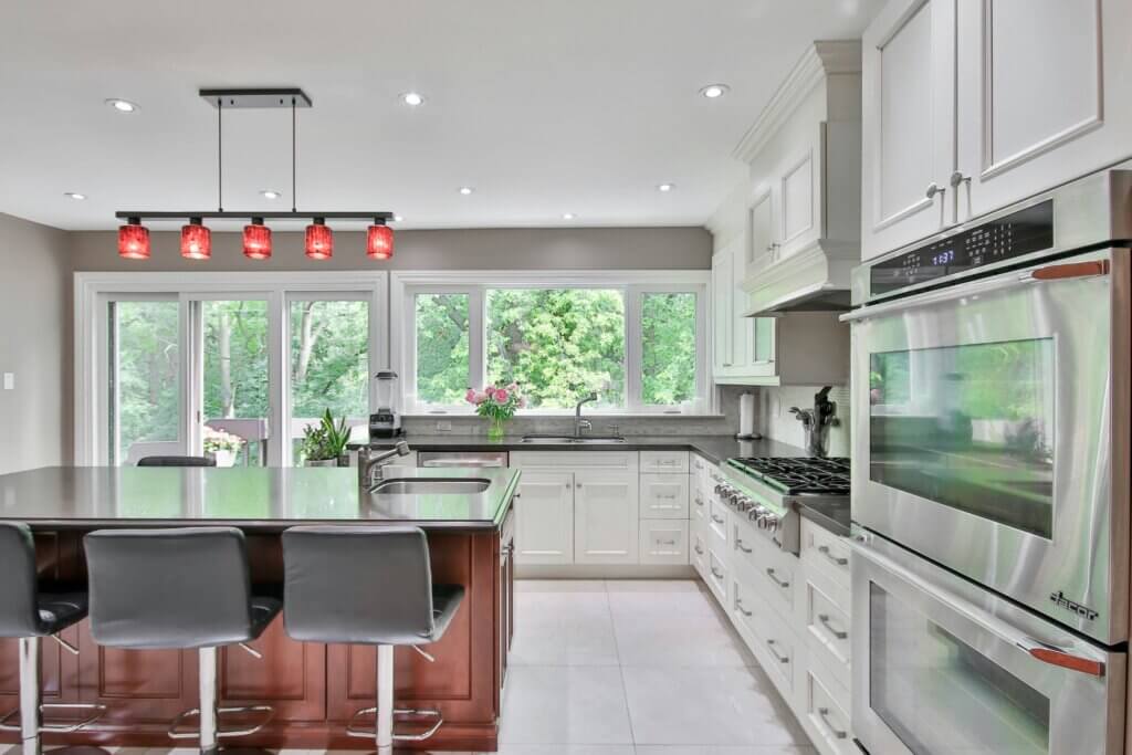 white kitchen with proper window placement and track lights