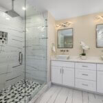 Spa-like bathroom with double vanity and mosaic shower tiles
