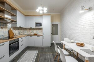 Kitchen with white cabinets, placemat and kitchen rug