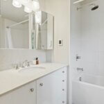 all white bathroom with classic cabinet and knob