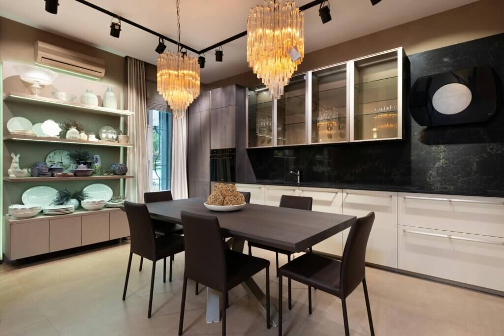 modern kitchen with chandeliers, open shelves, and wooden furniture 