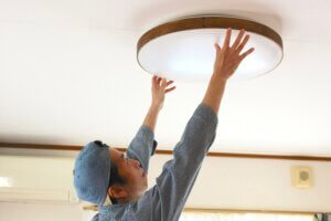Man installing ceiling light