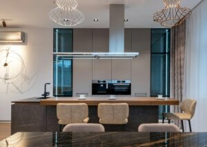 Modern kitchen with large kitchen island and statement lighting