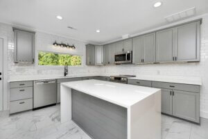 two-toned kitchen island with marble countertop