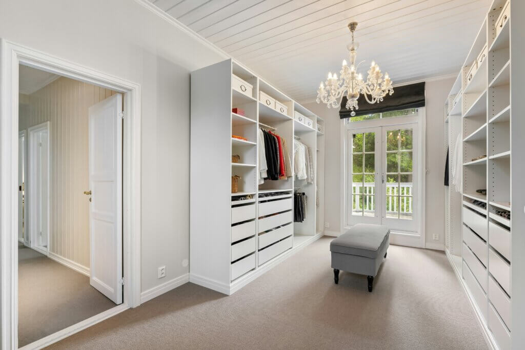 walkin closet with classic aesthetic and crystal chandelier