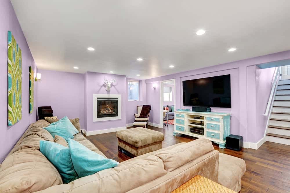 Traditional basement in soft lavender color scheme and neutral accents