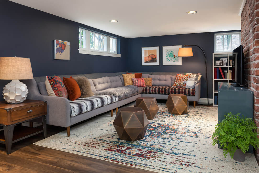 Eclectic basement with deep navy walls and accent